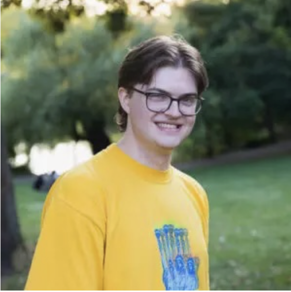 Daniel Graham sports a yellow shirt with some weird blue fingers on it. 
